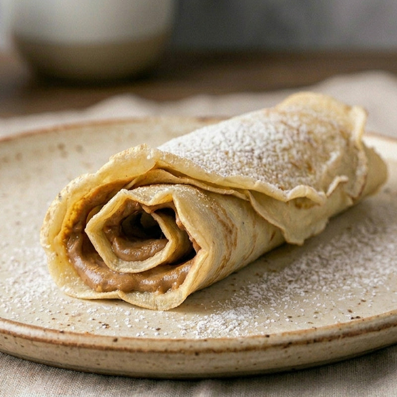 gerollter Pfannkuchen mit Cashewcreme auf Teller